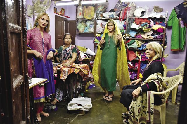 Rattigan (centre) drapes a dupatta around her head at Chandni Chowk’s Gupta Ladies’ Tailor Shop while the other two look on (Raj K Raj )