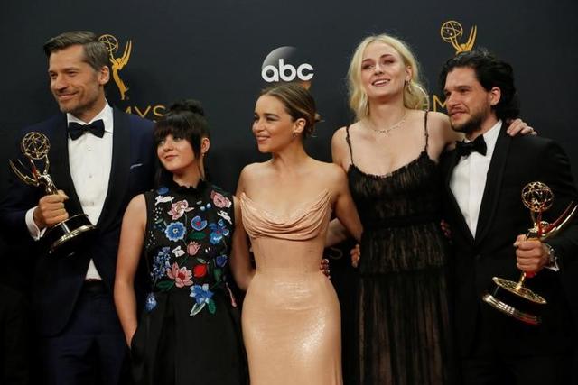 Nikolaj Coster-Waldau (left), Maisie Williams, Emilia Clarke, Sophie Turner and Kit Harrington of HBO's Game of Thrones pose backstage with their award for Oustanding Drama Series at the 68th Primetime Emmy Awards in Los Angeles. Nikolaj Coster-Waldau (left), Maisie Williams, Emilia Clarke, Sophie Turner and Kit Harrington of HBO's Game of Thrones pose backstage with their award for Oustanding Drama Series at the 68th Primetime Emmy Awards in Los Angeles.