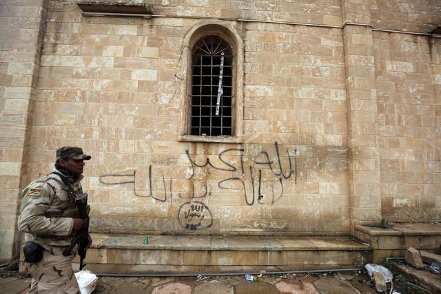Islamic State graffiti scribbled at the entrance of St George's Monastery, a historical Chaldean Catholic church on the outskirts of Mosul. (AFP) Islamic State graffiti scribbled at the entrance of St George's Monastery, a historical Chaldean Catholic church on the outskirts of Mosul. (AFP)