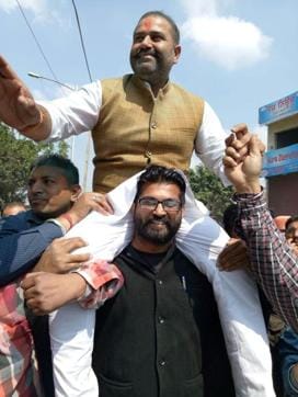 Congress candidate from Jalandhar West Sushil Rinku on the shoulders of one of his supporters after the victory on Saturday. (HT Photo)