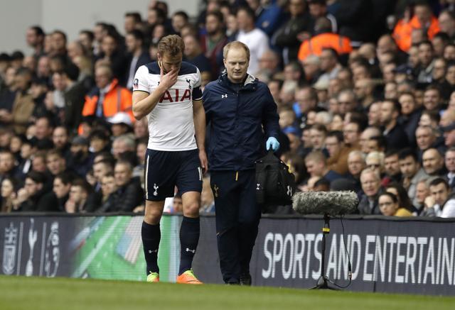 Tottenham's Harry Kane, left, leaves the pitch after getting injured against Millwall. (AP) Tottenham's Harry Kane, left, leaves the pitch after getting injured against Millwall. (AP)