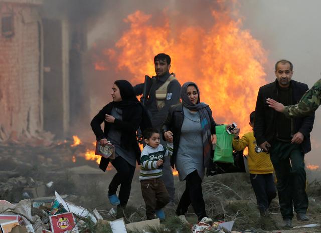 Survivors walk after the blast in Kabul on Monday. (REUTERS) Survivors walk after the blast in Kabul on Monday. (REUTERS)