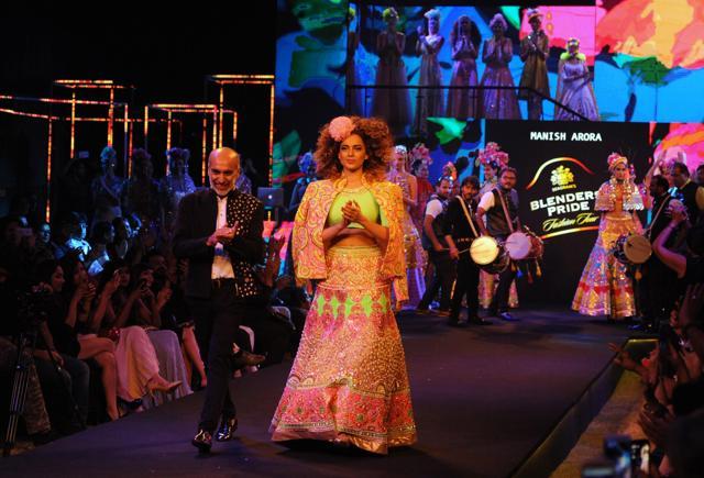 Kangana Ranaut showcases a creation by designer Manish Arora during the Blenders Pride Fashion Tour, where musicians such as Raghu Dixit and Midival Punditz played live music at the event. (AFP) Kangana Ranaut showcases a creation by designer Manish Arora during the Blenders Pride Fashion Tour, where musicians such as Raghu Dixit and Midival Punditz played live music at the event. (AFP)