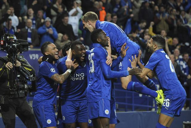 Leicester City's Wes Morgan, second left, celebrates with team mates after he scores a goal. (AP) Leicester City's Wes Morgan, second left, celebrates with team mates after he scores a goal. (AP)