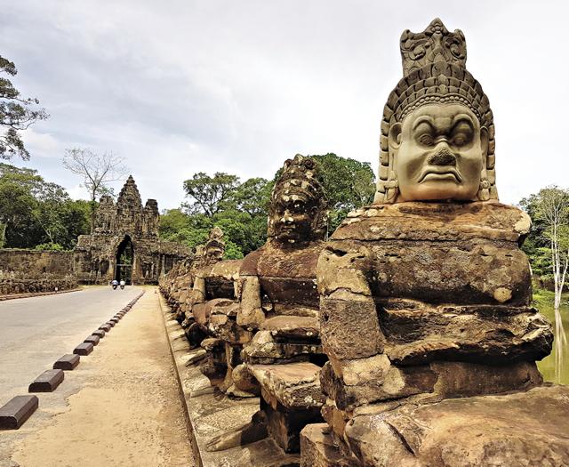The bridge to Angkor Thom is flanked by statues of demons on one side (Rick Roy) The bridge to Angkor Thom is flanked by statues of demons on one side (Rick Roy)