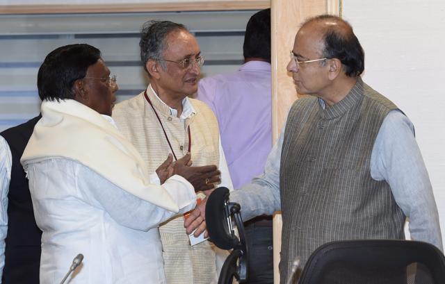 Union finance minister Arun Jaitley talks to West Bengal finance minister Amit Mitra (centre) and Puducherry chief minister V Narayanasami at the GST Council Meeting in New Delhi on Thursday. (PTI) Union finance minister Arun Jaitley talks to West Bengal finance minister Amit Mitra (centre) and Puducherry chief minister V Narayanasami at the GST Council Meeting in New Delhi on Thursday. (PTI)