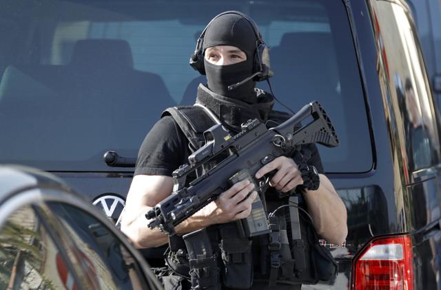 A member of a special police unit stands guard outside the Tocqueville high school. (REUTERS) A member of a special police unit stands guard outside the Tocqueville high school. (REUTERS)