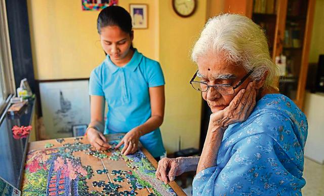 College student Nutan Ghag spends four hours a day with Chhaya Patil, 80, solving puzzles and reading to her at her Mumbai home. ‘It’s nice to have someone new to tell my stories to,’ Patil says. (Pratik Chorge/HT Photo)