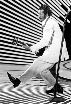 Chuck Berry performs his "duck walk" as he plays his guitar on stage on April 4, 1980. (AP File)