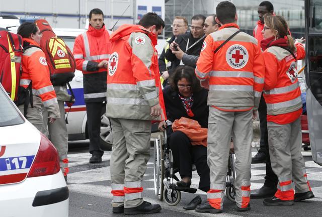 French Red Cross volunteers help a wowan evacuated at the Orly airport, south of Paris, on March 18. (AP Photo) French Red Cross volunteers help a wowan evacuated at the Orly airport, south of Paris, on March 18. (AP Photo)