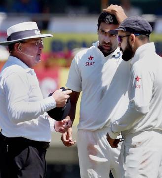 Virat Kohli and Ravichandran Ashwin talk to the umpire during 1st day's play in the Ranchi Test. (PTI)