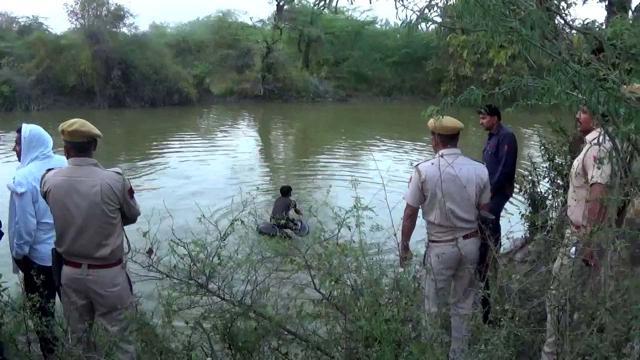 Several girls jumped into a pond to avoid police detention during a raid in a red light district in Bharatpur, Rajasthan. (HT Photo)