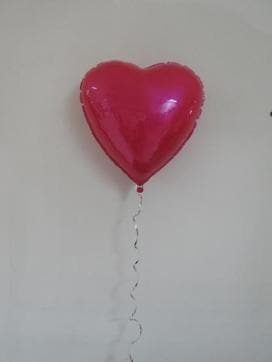 Ceramic sculpture, Metallic Pink Helium Heart by artist Sivan Sternbach from Israel,mounted on the wall.