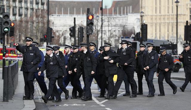 Police officers walk through Parliament in London, Wednesday, after the House of Commons sitting was suspended as witnesses reported sounds like gunfire outside. (AP Photo) Police officers walk through Parliament in London, Wednesday, after the House of Commons sitting was suspended as witnesses reported sounds like gunfire outside. (AP Photo)