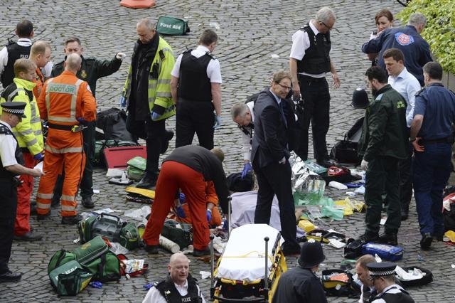 Conservative MP Tobias Ellwood, centre, stands amongst the emergency services at the scene outside the Palace of Westminster, London, Wednesday, March 22, 2017. (AP Photo) Conservative MP Tobias Ellwood, centre, stands amongst the emergency services at the scene outside the Palace of Westminster, London, Wednesday, March 22, 2017. (AP Photo)