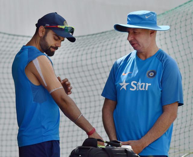 India cricket team skipper Virat Kohli with team physiotherapist Patrick Farhart during practice at HPCA Stadium in Dharamsala on Thursday (PTI) India cricket team skipper Virat Kohli with team physiotherapist Patrick Farhart during practice at HPCA Stadium in Dharamsala on Thursday (PTI)
