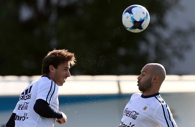 Argentina's Lucas Biglia heads the ball next to Javier Mascherano during a training session ahead of their match against Chile. (REUTERS) Argentina's Lucas Biglia heads the ball next to Javier Mascherano during a training session ahead of their match against Chile. (REUTERS)