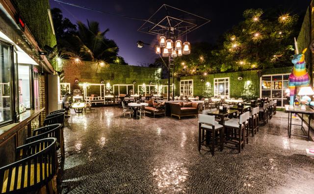 The al fresco courtyard with its lush, vertical garden fences the space off from the din of Juhu Circle. The al fresco courtyard with its lush, vertical garden fences the space off from the din of Juhu Circle.