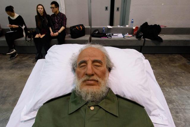 Visitors sit behind Chinese artist Shen Shaomin's Fidel Castro. (AFP Photo/Anthony Wallace) Visitors sit behind Chinese artist Shen Shaomin's Fidel Castro. (AFP Photo/Anthony Wallace)