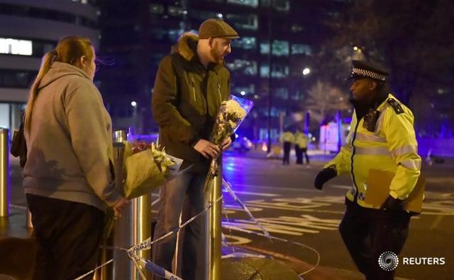 People leave flowers at the scene after an attack on Westminster Bridge in London. (Reuters)