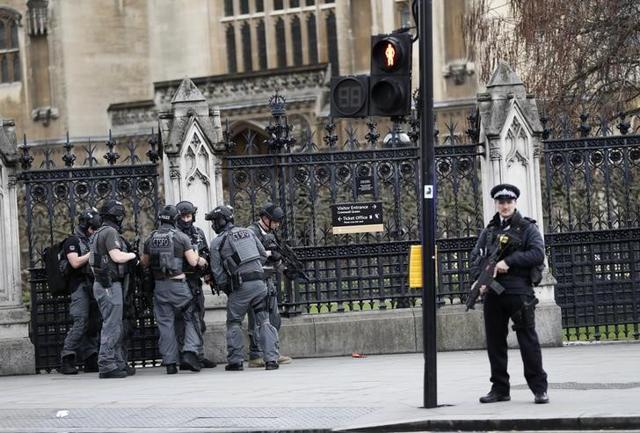 Armed police respond outside Parliament during the incident on Westminster Bridge. (Reuters)