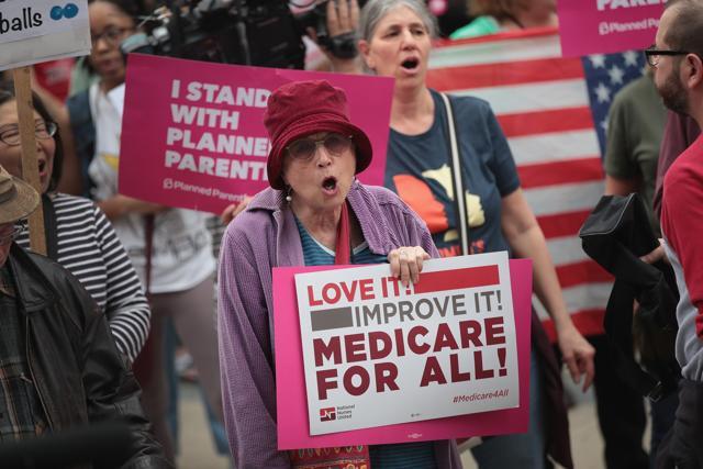 Demonstrators gather near Trump Tower to celebrate the defeat of revision of the Affordable Care Act on Friday in Chicago, Illinois. (AFP Photo)