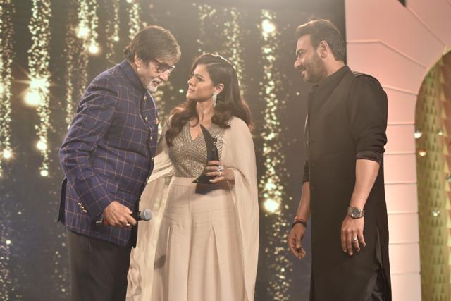 Ajay Devgn, Kajol and Amitabh Bachchan on the stage at the awards function. (Anshuman Poyrekar/HT Photo)
