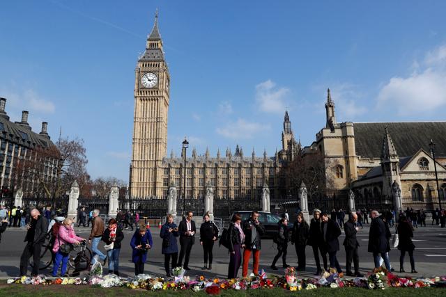People look at tributes left in Parliament Square following the Westminster attack. (Reuters) People look at tributes left in Parliament Square following the Westminster attack. (Reuters)