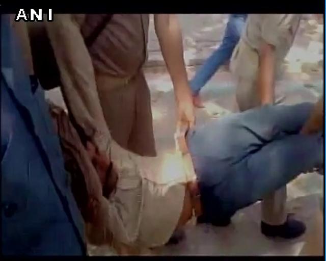 A prisoner being carried away by police officials after the protest. (ANI Twitter)