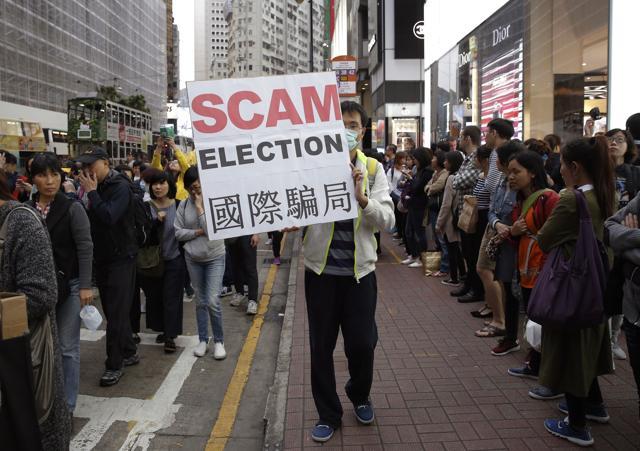 A pro-democracy protester displays a placard during a demonstration in Hong Kong to demand genuine universal suffrage. (AP Photo) A pro-democracy protester displays a placard during a demonstration in Hong Kong to demand genuine universal suffrage. (AP Photo)