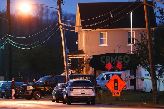A coroner's unit pulls away as police operate at a crime scene outside the Cameo club after a fatal shooting, Sunday, March 26, 2017, in Cincinnati. ) (AP) A coroner's unit pulls away as police operate at a crime scene outside the Cameo club after a fatal shooting, Sunday, March 26, 2017, in Cincinnati. ) (AP)