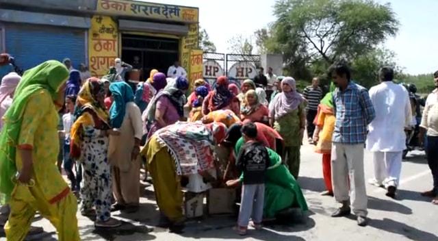 The protesting women throw liquor bottles on roads demanding shifting of a liquor shop from the village. (HT Photo) The protesting women throw liquor bottles on roads demanding shifting of a liquor shop from the village. (HT Photo)