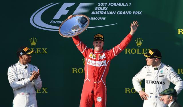 Ferrari's German driver Sebastian Vettel (C) celebrates on the podium with Mercedes' British driver Lewis Hamilton (L) and Mercedes' Finnish driver Valtteri Bottas (R) after winning the Formula One Australian Grand Prix in Melbourne on Sunday. (AFP) Ferrari's German driver Sebastian Vettel (C) celebrates on the podium with Mercedes' British driver Lewis Hamilton (L) and Mercedes' Finnish driver Valtteri Bottas (R) after winning the Formula One Australian Grand Prix in Melbourne on Sunday. (AFP)