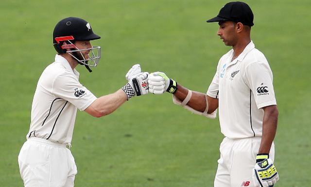 Kane Williamson (L) and Jeet Raval touch gloves during day three of the third Test cricket match between New Zealand and South Africa. (AFP/Getty Images)