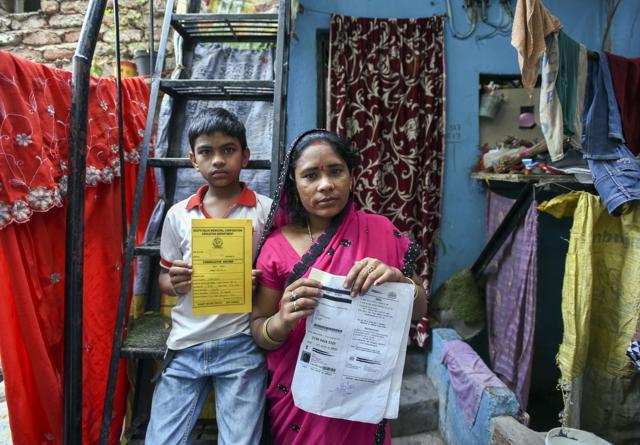 Swayam Gupta , with his mother Geeta. Swayam has lost out on a school scholarship because his name is misspelt on his Aadhaar card. (Arun Sharma/HT PHOTO)