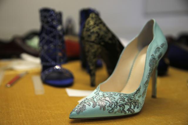 A picture shows a woman shoe with silver dust patterns made by artisans for A&amp;V Fashion. (AFP Photo)