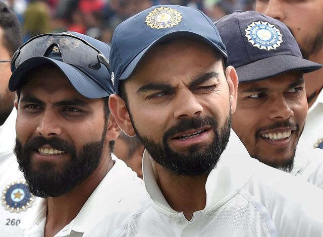 Virat Kohli with teammates Ravindra Jadeja and Umesh Yadav at award ceremony after winning the series against Australia on the 4th day of last match at HPCA Stadium in Dharamsala on Tuesday. (PTI) Virat Kohli with teammates Ravindra Jadeja and Umesh Yadav at award ceremony after winning the series against Australia on the 4th day of last match at HPCA Stadium in Dharamsala on Tuesday. (PTI)