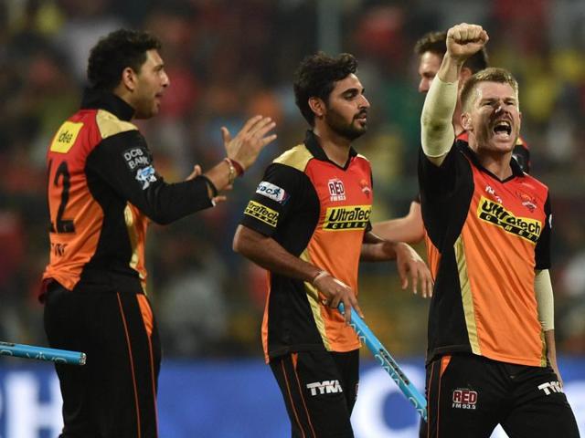 Warner with a jubilant fist pump as teammates rush in to celebrate. (PTI)