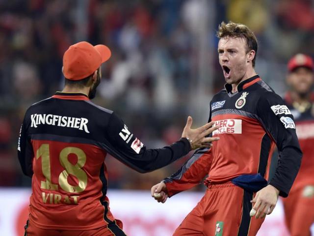 RCB players Virat Kohli and AB de Villiers celebrate a wicket during an IPL league match with Mumbai Indians at M Chinnaswamy Stadium, Bangalore on May 11, 2016. (Vipin Kumar / HT Photo) 