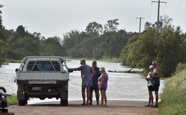 People look at flooding from Burdekin River which has risen some 10 metres in Ayr in Queenland on March 30, after the area was hit by Cyclone Debbie. (AFP Photo) People look at flooding from Burdekin River which has risen some 10 metres in Ayr in Queenland on March 30, after the area was hit by Cyclone Debbie. (AFP Photo)