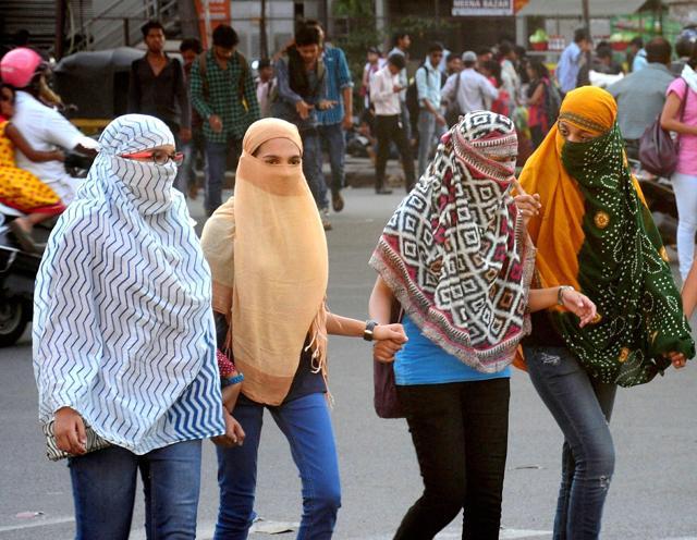 Girls cover their faces to protect themselves from scorching heat in Nagpur, Maharashtra on Thursday. (PTI Photo) Girls cover their faces to protect themselves from scorching heat in Nagpur, Maharashtra on Thursday. (PTI Photo)