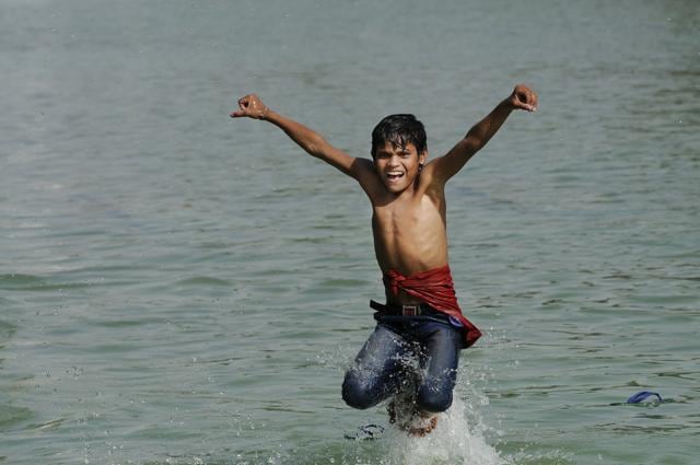 A boy cools off in a water channel near India Gate to get respite from the heat in New Delhi. (Burhaan Kinu/HT Photo) A boy cools off in a water channel near India Gate to get respite from the heat in New Delhi. (Burhaan Kinu/HT Photo)