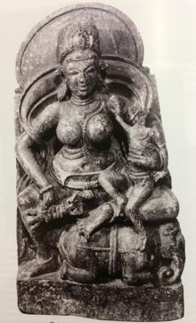 Seated Indrani, holding vajra and child. (Courtesy Trustees of the British Museum, London)