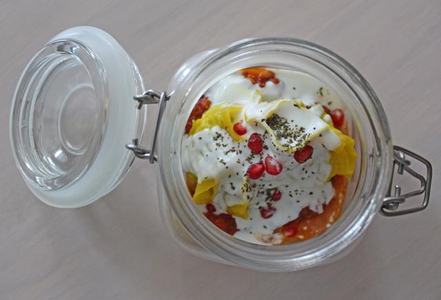 Mantu, tortellini-like dumplings, are served on a hearty lentil-tomato sauce under tangy yogurt, stuffed with minced veggies. (Satyabrata Tripathy / HT Photo)