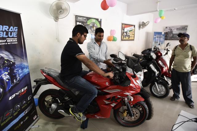 Customer try out bikes at a Suzuki showroom. (Burhaan Kinu/HT PHOTO) Customer try out bikes at a Suzuki showroom. (Burhaan Kinu/HT PHOTO)