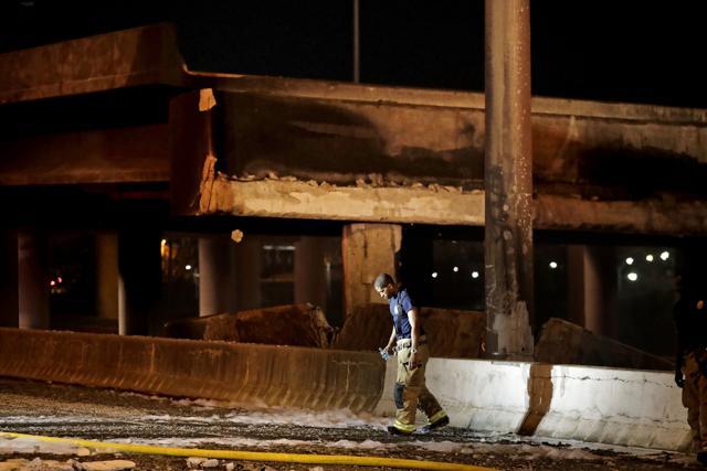 A firefighter walks by the section of an overpass that collapsed from a large fire on Interstate 85 in Atlanta, Thursday, March 30. (AP Photo) A firefighter walks by the section of an overpass that collapsed from a large fire on Interstate 85 in Atlanta, Thursday, March 30. (AP Photo)