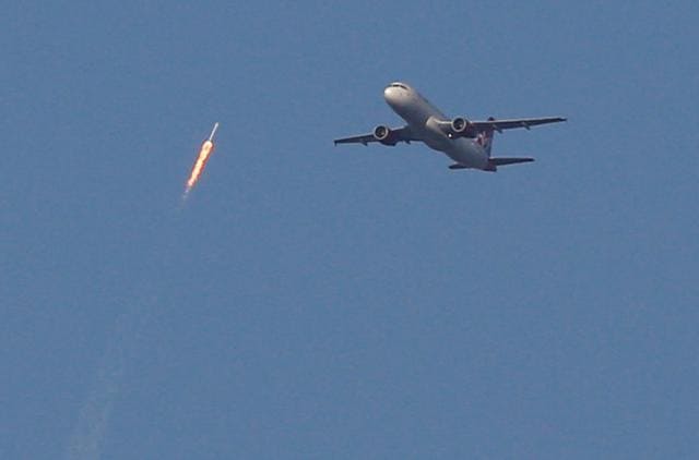 A recycled SpaceX Falcon 9 rocket soars toward space above a Virgin Airlines passenger jet, which had just departed Orlando International Airport, in Orlando, Florida. (Reuters Photo) A recycled SpaceX Falcon 9 rocket soars toward space above a Virgin Airlines passenger jet, which had just departed Orlando International Airport, in Orlando, Florida. (Reuters Photo)