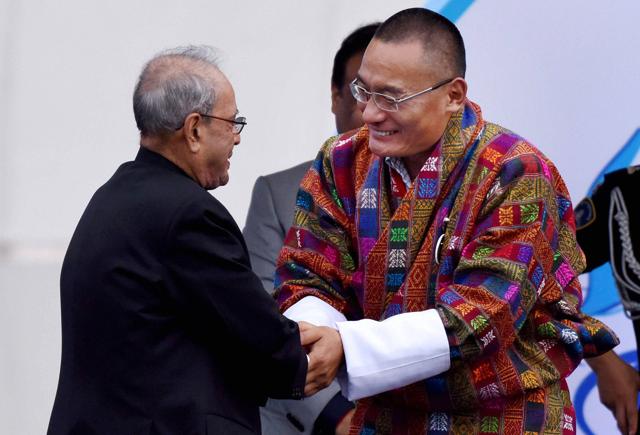 President Pranab Mukherjee shakes hands with Bhutan Prime Minister Tshering Tobgay at the Namami Brahmaputra festival in Guwahati on Friday. (PTI) President Pranab Mukherjee shakes hands with Bhutan Prime Minister Tshering Tobgay at the Namami Brahmaputra festival in Guwahati on Friday. (PTI)