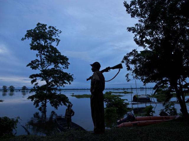 A forest guard keeps vigil at the Kaziranga National Park in Assam state during the floods last year. (AP FILE PHOTO) A forest guard keeps vigil at the Kaziranga National Park in Assam state during the floods last year. (AP FILE PHOTO)