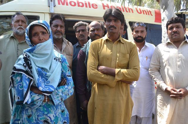Pakistani relatives wait at a hospital to receive the bodies of victims murdered at a Sufi shrine in Punjab province on Sunday. (AFP)